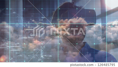 Man using VR headset exploring digital cloud technology in modern office 126485795