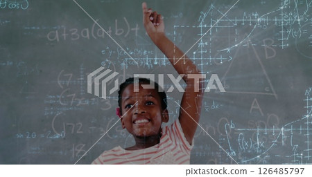 In school, smiling girl raising hand in classroom, eager to answer question In school, smiling girl raising hand in classroom, eager to answer question 126485797