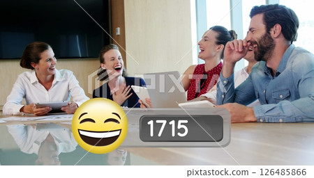 Business team laughing together in conference room, holding tablets and papers Business team laughing together in conference room, holding tablets and papers 126485866