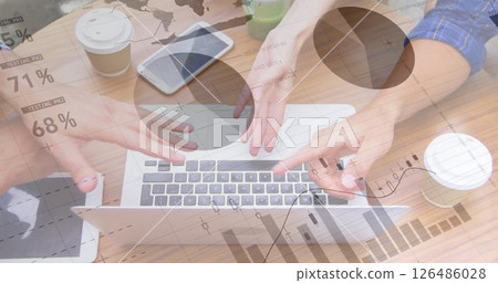 Analyzing data charts, two people collaborating with laptop, coffee, and tablet nearby Analyzing data charts, two people collaborating with laptop, coffee, and tablet nearby 126486028