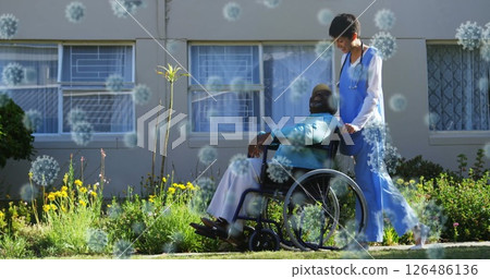 Assisting man in wheelchair, healthcare worker outdoors with virus concept overlay 126486136