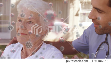 Supporting elderly woman, healthcare worker with virus particles overlaying image 126486138