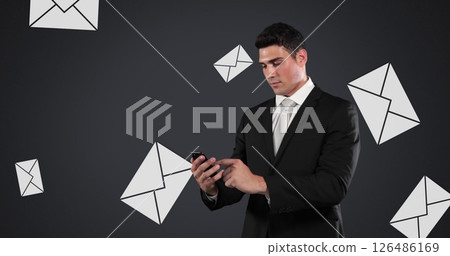 Businessman in suit checking smartphone, surrounded by floating email icons Businessman in suit checking smartphone, surrounded by floating email icons 126486169