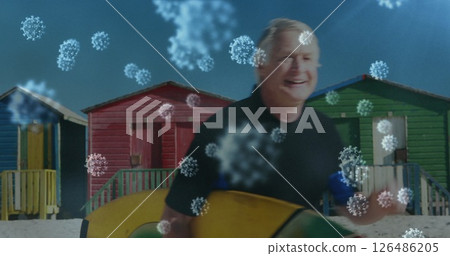 Image of cells floating over senior caucasian man standing on a beach, holding a surfboard 126486205
