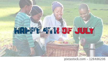 African American family enjoying picnic in park celebrating Fourth of July together African American family enjoying picnic in park celebrating Fourth of July together 126486206