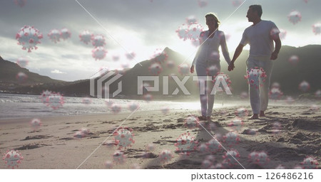 Image of cells floating over caucasian couple walking on a beach, holding hands Image of cells floating over caucasian couple walking on a beach, holding hands 126486216