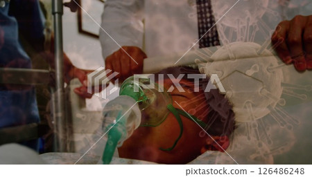 Medical team assisting patient with oxygen mask in hospital during pandemic crisis Medical team assisting patient with oxygen mask in hospital during pandemic crisis 126486248