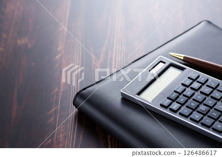 Black calculator and binder 126486617