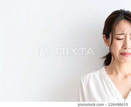 Sad expression of a woman shedding tears 126486633