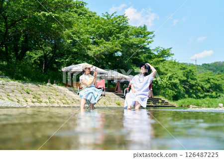 woman cooling off in the river woman cooling off in the river 126487225