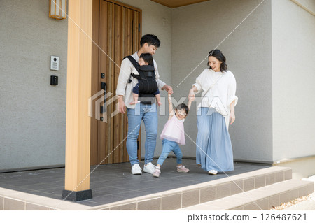 An image of a family of four leaving through the front door 126487621