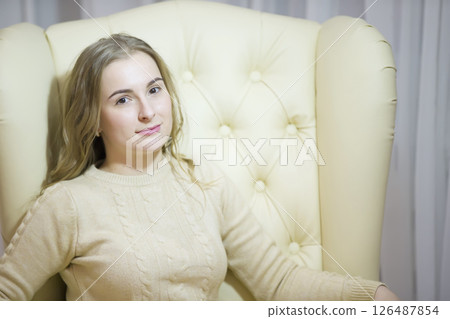 Portrait of a young woman in beige clothes Portrait of a young woman in beige clothes 126487854