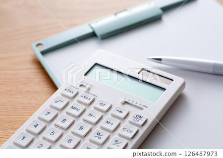 White calculator and binder 126487973