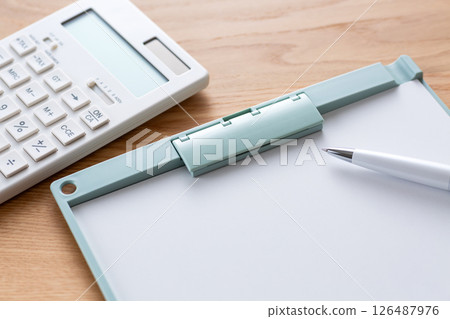White calculator and binder 126487976