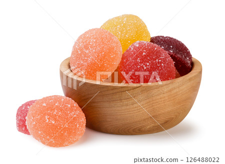 Marmalade candies in a wooden plate on a white background. Isolated 126488022