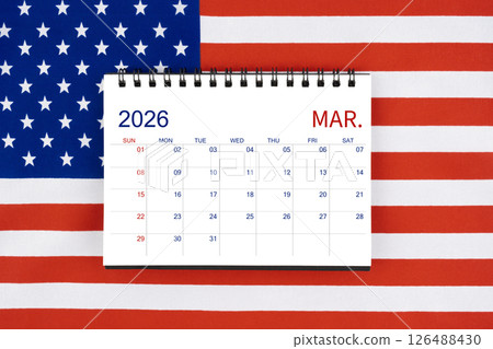 March 2026 desk calendar on United States of America flag. March 2026 desk calendar on United States of America flag. 126488430