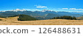 Mountain Landscape with Snowy Peaks and Forest Cabins 126488631