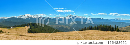 Mountain Landscape with Snowy Peaks and Forest Cabins 126488631