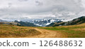 Winding Dirt Road Through Hills Toward Misty Mountains 126488632