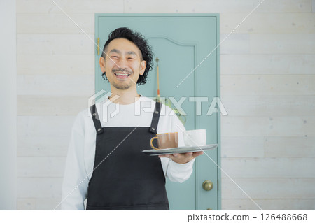 Bearded male cafe clerk 126488668