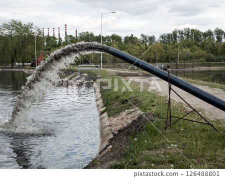 Dumping of industrial waste from plastic pipe. Dumping of industrial waste from plastic pipe. 126488801