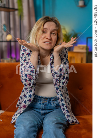 Confused Caucasian woman feeling embarrassed about ambiguous question having doubts no idea clueless Confused Caucasian woman feeling embarrassed about ambiguous question having doubts no idea clueless 126489265