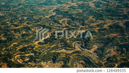 View From Airplane Window On Surroundings Of Chengdu, China. Private Buildings. Discover China. Mountainous Wooded Terrain Landscape Of China. Porthole View Or Called Bull's-eye Window 126489335