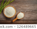 Raw rice in wooden bowl on old wooden table, rice top view. 126489665