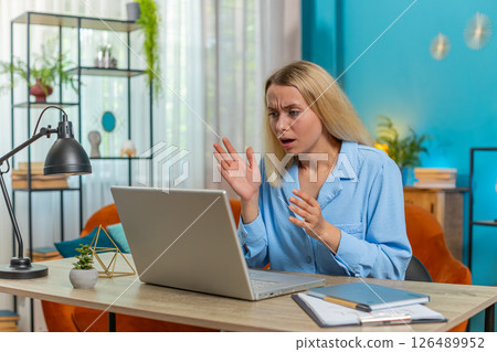 Frustrated woman having software problems with laptop angry girl nervous seeing error mistake virus 126489952