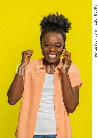 Happy woman in pleasant conversation on smartphone, enjoying talking with friend good news, gossip 126490099