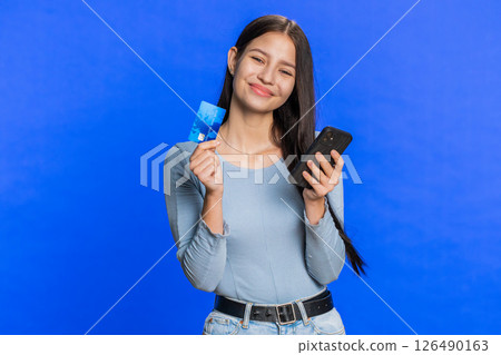 Woman use credit bank card smartphone while transferring spending money, purchases online shopping 126490163