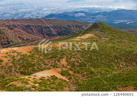 A view of the autumn leaves on the mountainside and the townscape in the direction of Fukushima City from the summit of Mt. Adatara 126490691
