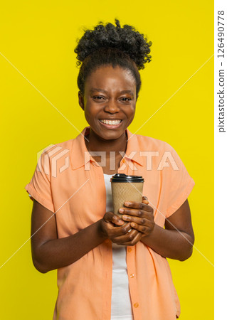 African American woman enjoying drinking morning coffee, plastic cup in hand, satisfied expression 126490778