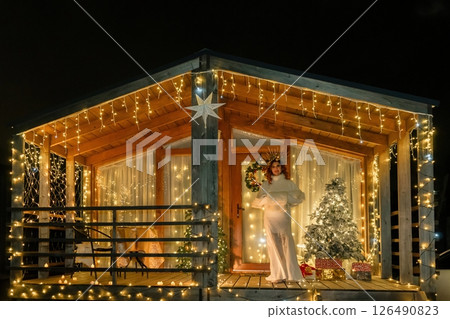 Christmas Lights Cabin Woman Holding Candle Night 126490823