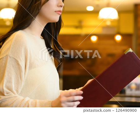 A female customer perusing the menu A female customer perusing the menu 126490900
