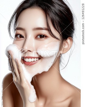 Korean woman demonstrates skincare routine with cleansing foam for radiant complexion and healthy skin 126491228