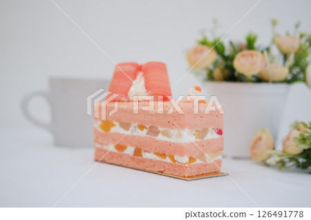 Piece of cake and cup of tea on white background, stock photo 126491778