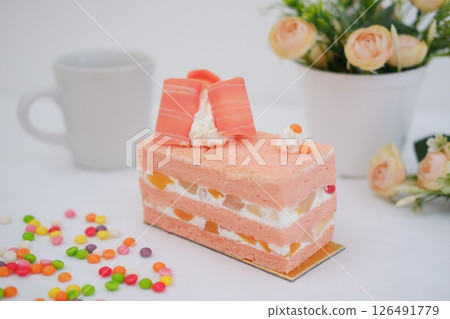Piece of cake and cup of tea on white background, stock photo 126491779
