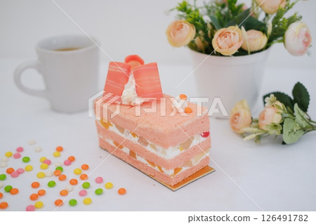 Piece of cake and cup of tea on white background, stock photo 126491782
