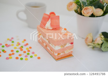 Piece of cake and cup of tea on white background, stock photo 126491786