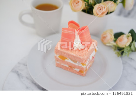 Piece of cake and cup of tea on white background, stock photo 126491821