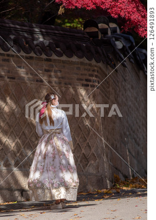 Tourist in traditional Korean Hanbok dress visiting Changdeokgung royal palace of the Joseon dynasty in Seoul, South Korea Tourist in traditional Korean Hanbok dress visiting Changdeokgung royal palace of the Joseon dynasty in Seoul, South Korea 126491893
