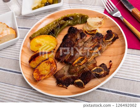 Popular dish of grilled beef Churrasco, potatoes and peppers 126492002