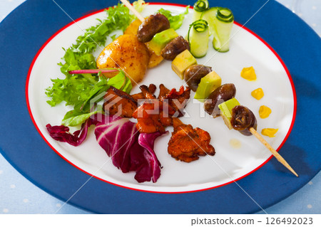 Plate of delicious chicken hearts on skewer 126492023