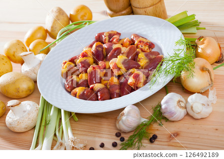 Raw chicken hearts with fresh vegetables 126492189