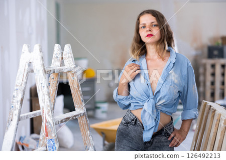 Young seductive woman posing in apartment during repair works Young seductive woman posing in apartment during repair works 126492213