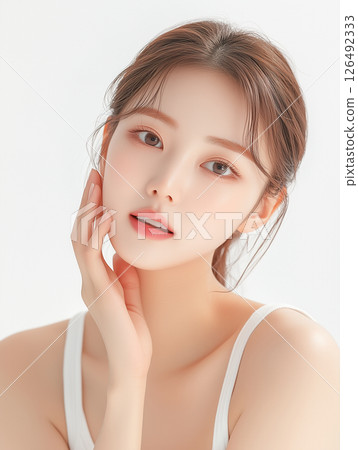 Korean model showcases radiant skin and minimalist beauty in a soft studio setting Korean model showcases radiant skin and minimalist beauty in a soft studio setting 126492333
