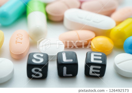 SLE systemic Lupus erythematosus or Lupus word with pills and capsules medical drug. SLE systemic Lupus erythematosus or Lupus word with pills and capsules medical drug. 126492573