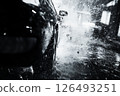 View of a car being washed with splashes of water captured from a low angle during an evening clean 126493251