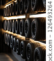 High end tire display in modern garage showcasing premium tire selection under warm lighting 126493264